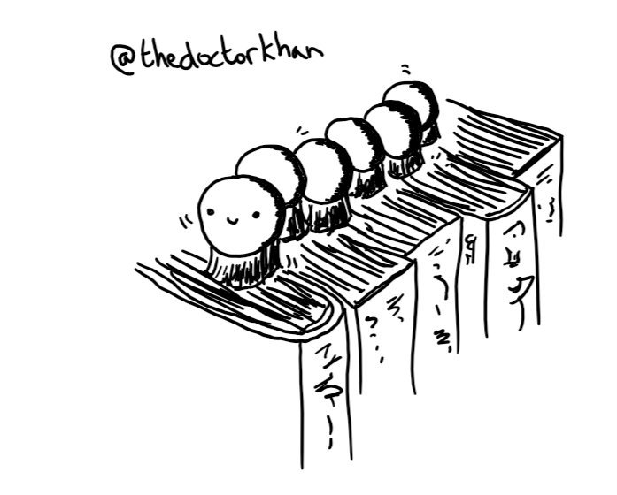 A robot composed of six small spheres, arranged in a row like a caterpillar, with a smiley face on the foremost one. Instead of legs it has a little round brush on the bottom of each sphere and is making its way along a row of books.