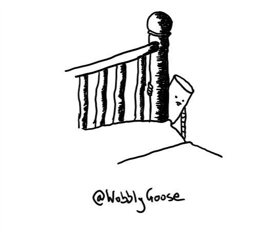 A cylindrical robot hanging from a bedpost, extending one arm down below the level of the quilt. Its tongue is sticking out in concentration.