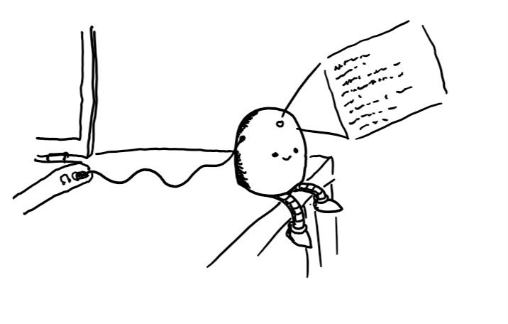 A happy, round-topped robot with no arms sitting on the edge of a desk with a wire running from its side into a laptop's audio jack. A little emitter in the middle of its forehead projects a small holographic window filled with text.