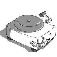 A low, cuboid robot with wheels on its underside and two banded arms positioned towards the near ends of its long sides. Its face is on a short side and it has a large domed bell on its back. The robot looks frightened and is holding one hand over its mouth as it raises a small hammer with the other, poised to strike the bell.