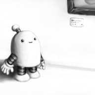 A full colour, 'art style' picture of a white robot with a rounded top, banded arms and legs and an antenna, standing in an entirely white section of an art gallery, looking up and smiling at the bottom edge of a vibrantly-painted framed picture that is pink with green and yellow shapes visible. There's a label underneath the picture with illegible text on it, and behind the robot is a white pedestal standing slightly away from the wall, with some sort of blue glass or ceramic object on it.