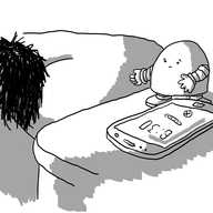 A round-topped robot standing on a bedside cabinet beside a phone showing a 6.30 alarm going off. In the bed is a person turned away and wrapped in covers. The robot looks slightly worried.